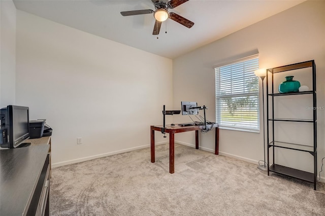 carpeted home office featuring ceiling fan