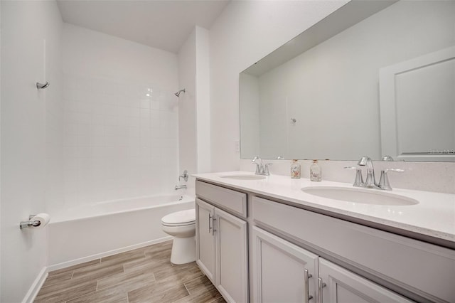 full bathroom featuring vanity, bathing tub / shower combination, and toilet