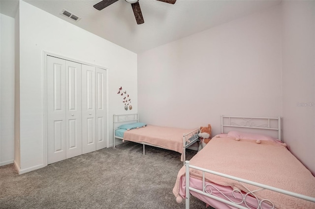 carpeted bedroom featuring ceiling fan and a closet