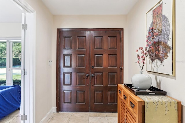 foyer entrance with light tile patterned floors