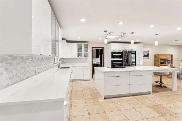 kitchen featuring white cabinetry, a large island, sink, stainless steel fridge with ice dispenser, and decorative light fixtures