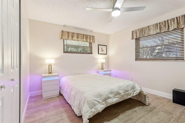 bedroom featuring ceiling fan, a textured ceiling, and a closet