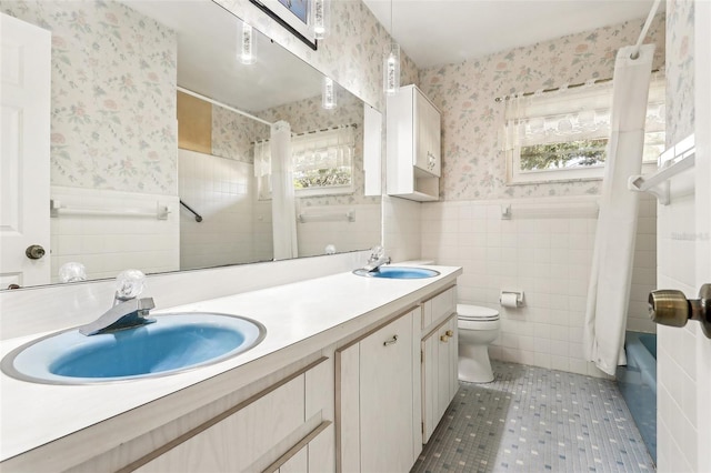 bathroom with tile patterned flooring, vanity, and toilet