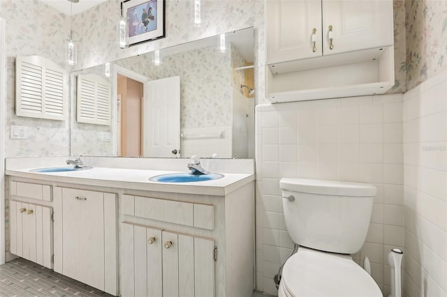 bathroom with tile patterned flooring, vanity, and toilet