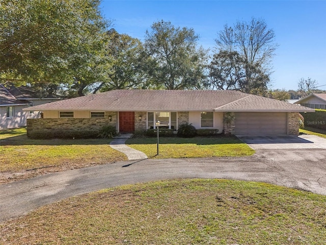 ranch-style home with a front lawn and a garage