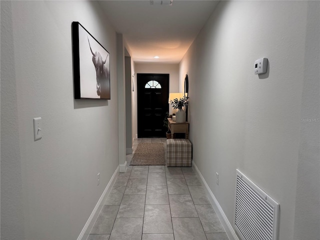 corridor with light tile patterned floors