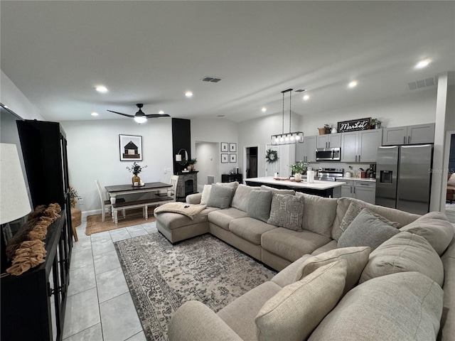 tiled living room with ceiling fan