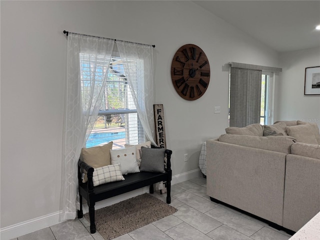 living room featuring light tile patterned floors and vaulted ceiling