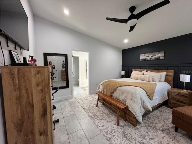 bedroom with ceiling fan, light tile patterned floors, and lofted ceiling