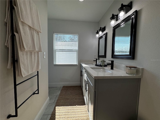 bathroom featuring tile patterned flooring and vanity