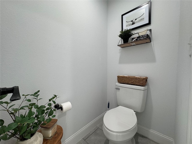 bathroom with toilet and tile patterned floors