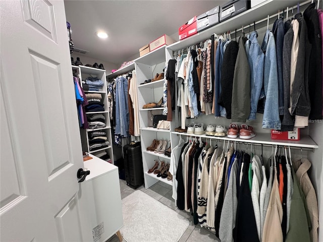 spacious closet featuring light tile patterned floors