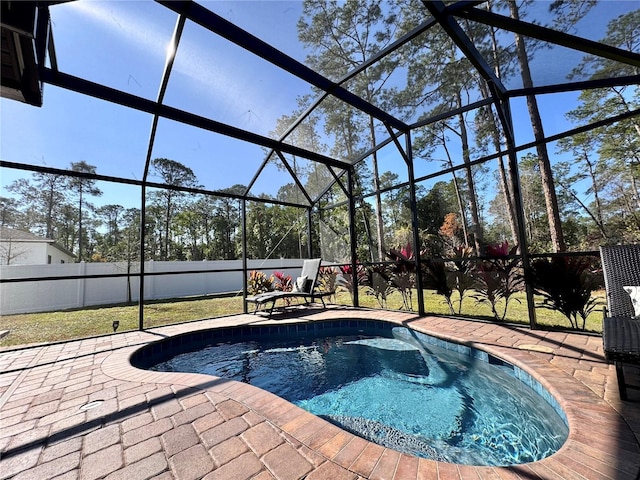 view of swimming pool with a patio and glass enclosure