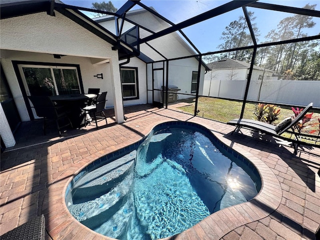 view of swimming pool featuring a grill, a patio, and glass enclosure