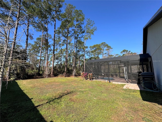 view of yard featuring glass enclosure