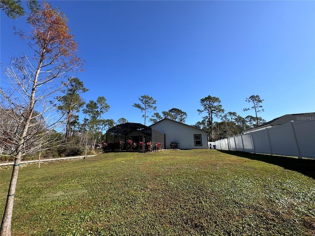 view of yard featuring glass enclosure