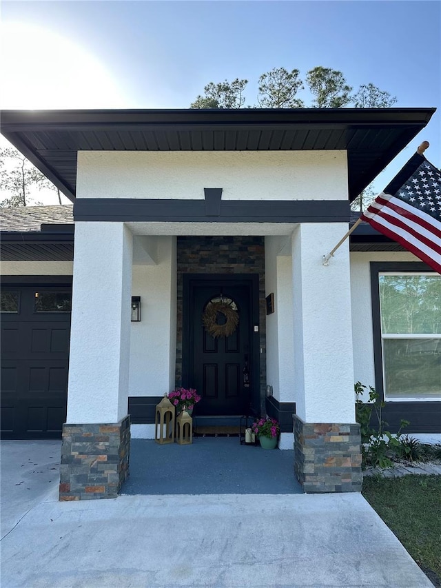 doorway to property featuring stucco siding