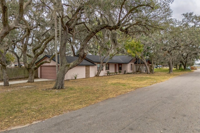 view of front of property with a garage and a front lawn