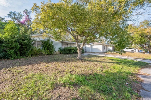 view of front of home with a garage and a front lawn