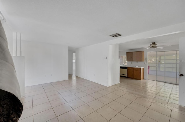 unfurnished living room featuring ceiling fan and light tile patterned floors