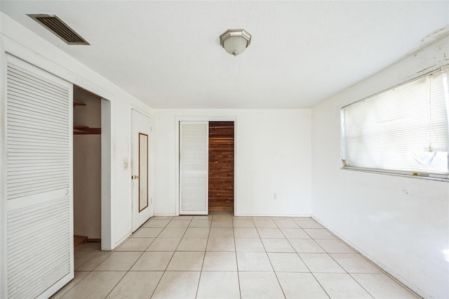 unfurnished bedroom featuring multiple closets