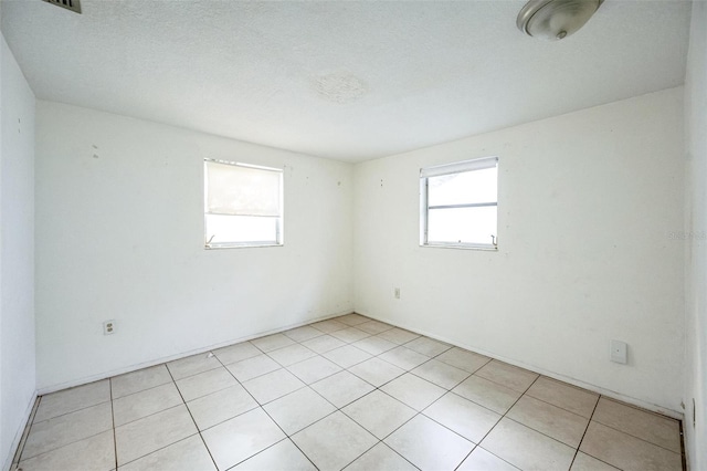 spare room with a healthy amount of sunlight and a textured ceiling