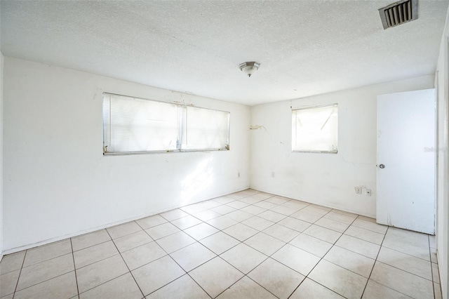 unfurnished room featuring a textured ceiling