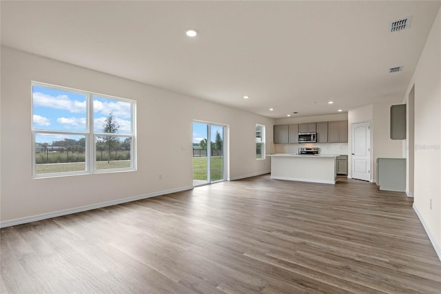 unfurnished living room featuring dark hardwood / wood-style floors