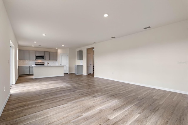 unfurnished living room with light wood-type flooring