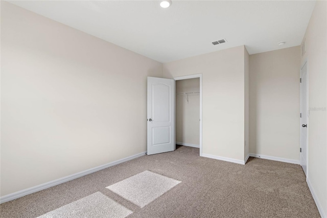 unfurnished bedroom with a closet and carpet