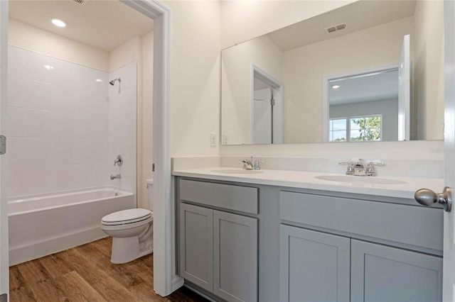 full bathroom with wood-type flooring, vanity, toilet, and shower / bathtub combination