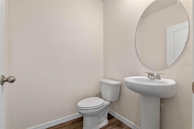 bathroom featuring hardwood / wood-style floors, toilet, and sink