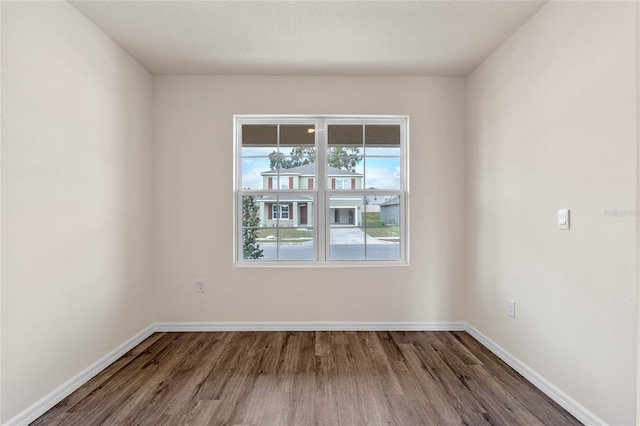 unfurnished room with wood-type flooring