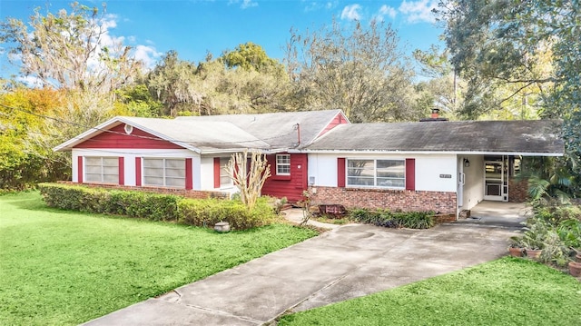 single story home with a front lawn and a carport