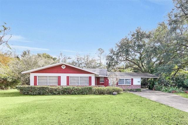 ranch-style house featuring a carport and a front lawn