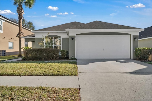 ranch-style house with a garage and a front lawn