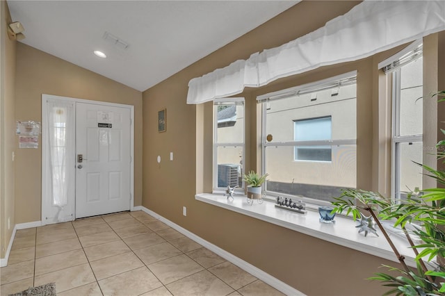 tiled entryway with lofted ceiling