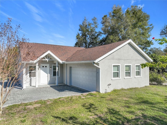 ranch-style house with a garage and a front lawn