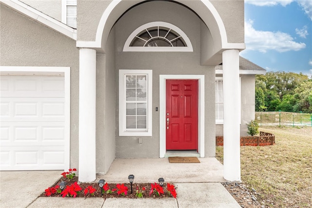 entrance to property with a lawn