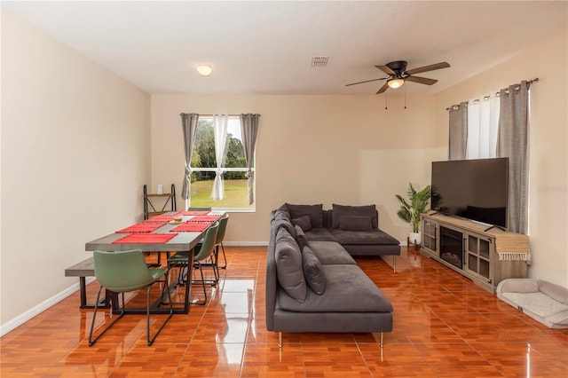 tiled living room featuring ceiling fan