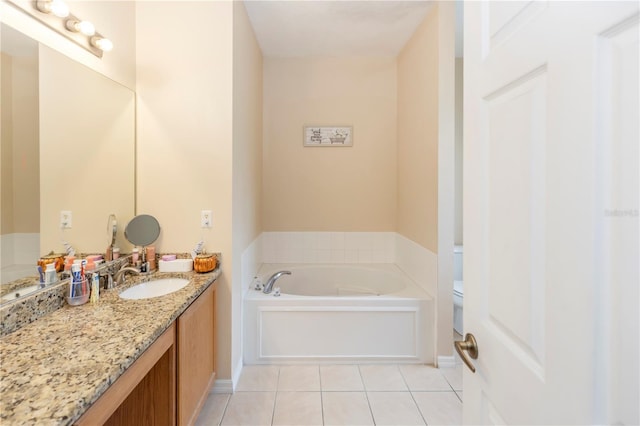 bathroom featuring a washtub, tile patterned flooring, vanity, and toilet