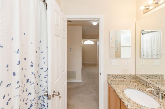 bathroom with a shower with shower curtain and vanity