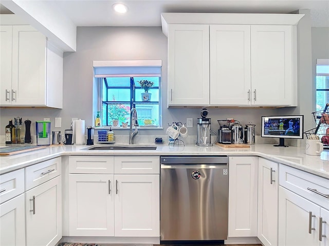 kitchen featuring a sink, white cabinets, dishwasher, and light countertops