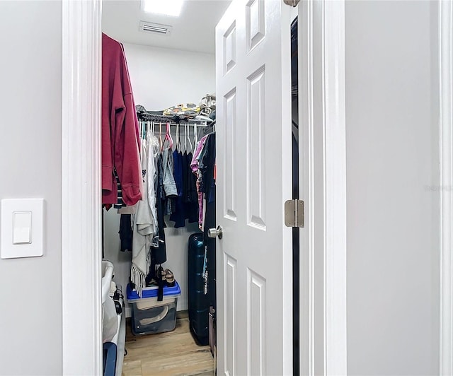 spacious closet featuring wood finished floors and visible vents