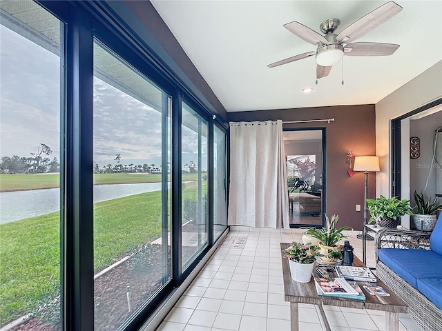 interior space with a water view and ceiling fan