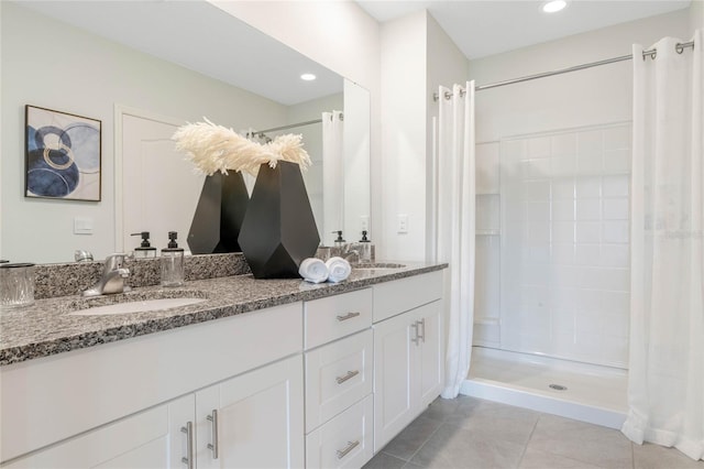 bathroom with tile patterned floors, curtained shower, and vanity