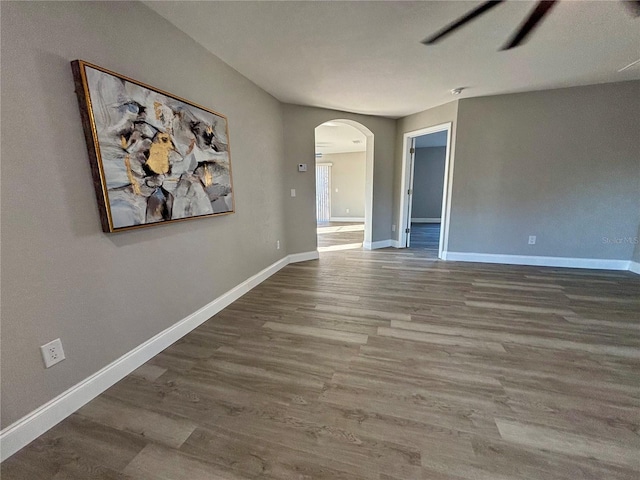 unfurnished room with hardwood / wood-style flooring and ceiling fan