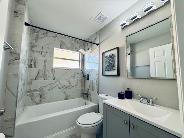 full bathroom with vanity, toilet, and tiled shower / bath