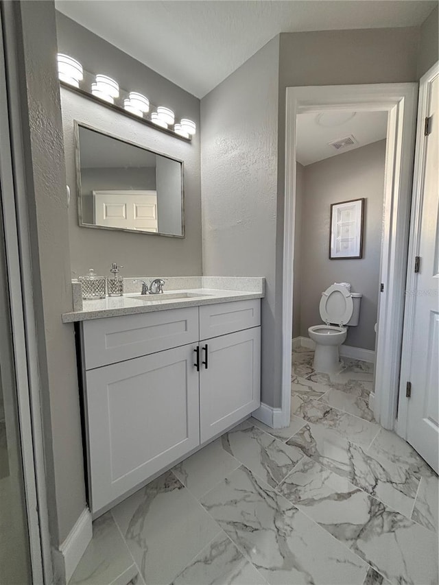 bathroom with vanity and toilet