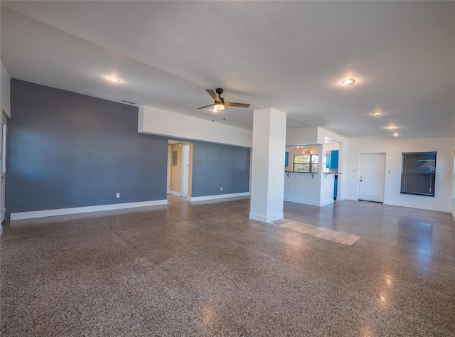 unfurnished living room with ceiling fan